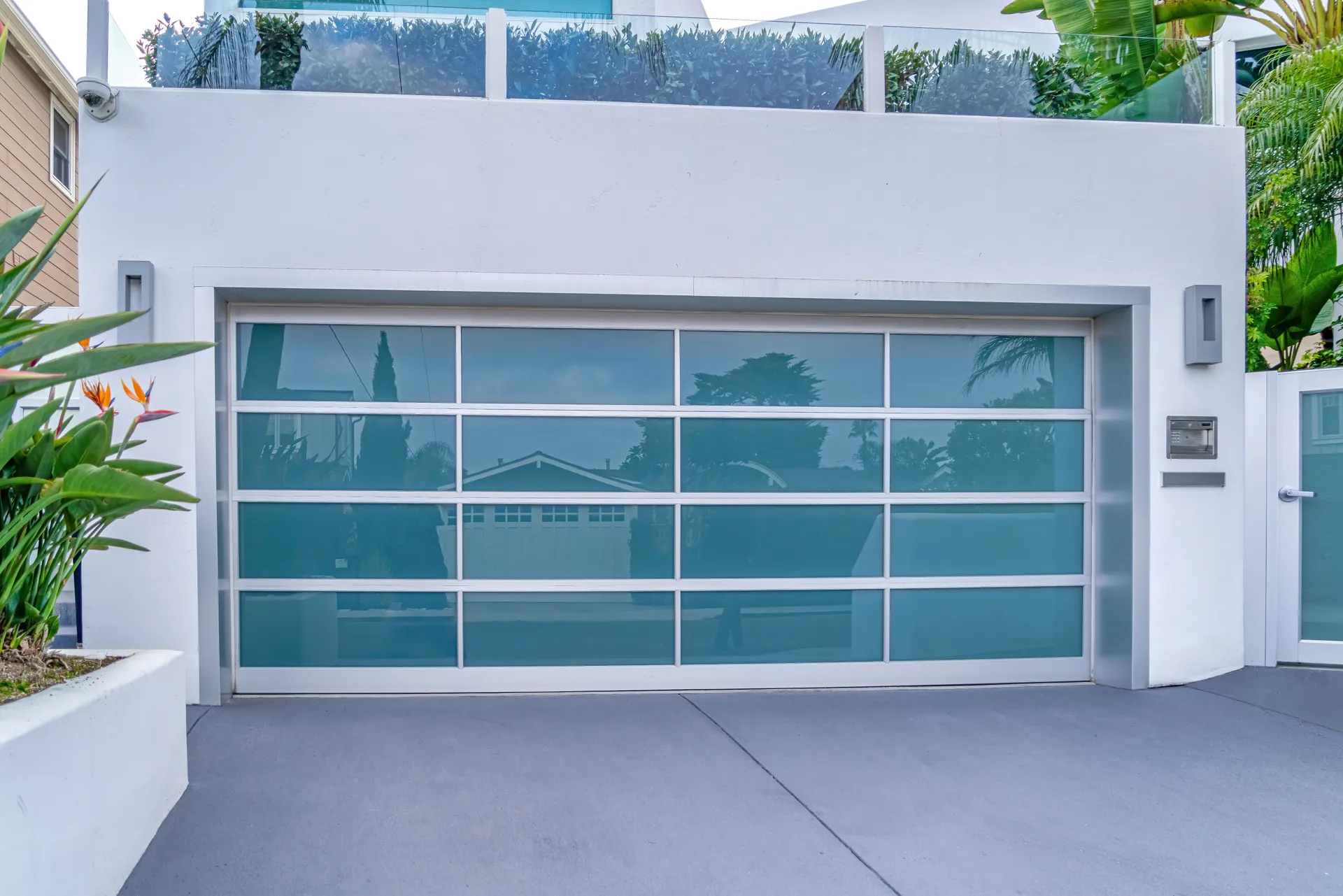 Modern glass-paneled garage door on contemporary home